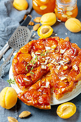 Image showing Sliced caramelized tarte tatin pie with apricots.