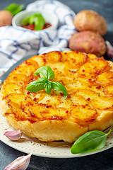 Image showing Traditional Tarte Tatin with potatoes and garlic.