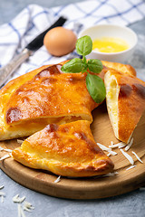 Image showing Cut closed pie with cheese and egg (khachapuri).