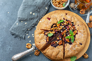 Image showing Cut galette pie with oats, currants and walnuts.