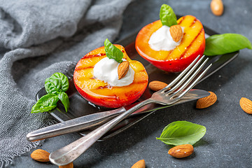 Image showing Grilled peach with honey, yogurt and almonds.