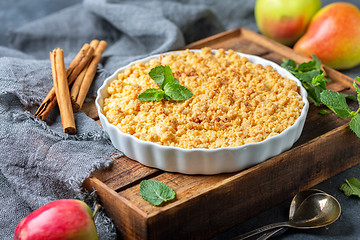 Image showing  Apple crumble in white ceramic baking form.