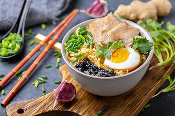 Image showing Spicy soup with noodles and meat in Asian style.