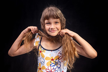 Image showing Portrait of a girl who made a headscarf out of hair on her head