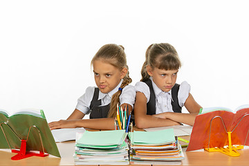 Image showing Two quarreling girls at the same desk