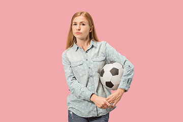 Image showing Fan sport woman player holding soccer ball isolated on pink background