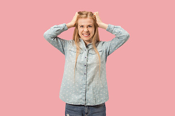 Image showing Portrait of an angry woman looking at camera isolated on a pink background