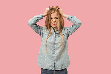 Image showing Portrait of an angry woman looking at camera isolated on a pink background