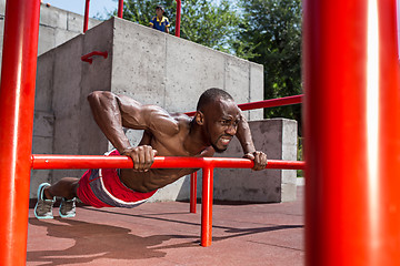 Image showing Athlete doing exercises at stadium