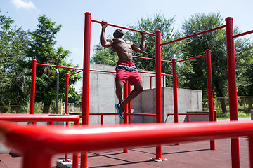 Image showing Athlete doing exercises at stadium