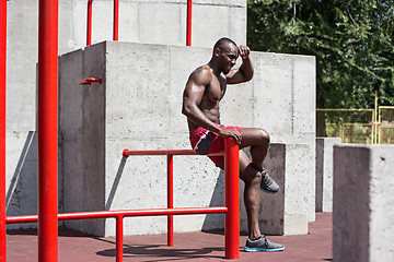 Image showing Athlete doing exercises at stadium