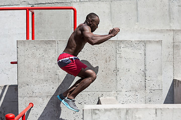 Image showing Athlete doing exercises at stadium