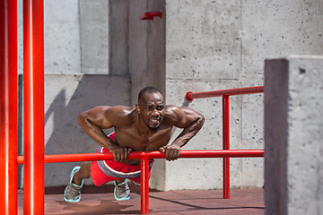 Image showing Athlete doing exercises at stadium