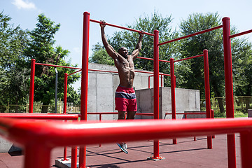 Image showing Athlete doing exercises at stadium