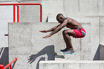 Image showing Athlete doing exercises at stadium