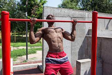 Image showing Athlete doing exercises at stadium