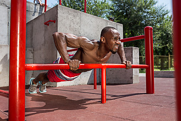 Image showing Athlete doing exercises at stadium