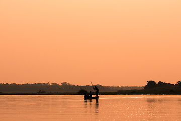 Image showing Men in a boat on a river silhouette