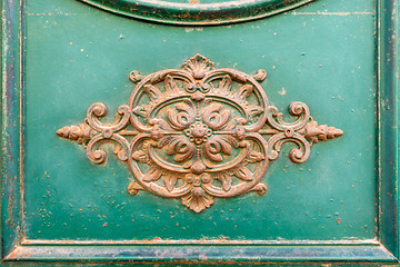 Image showing rusty ornamental decoration at a green door in Italy