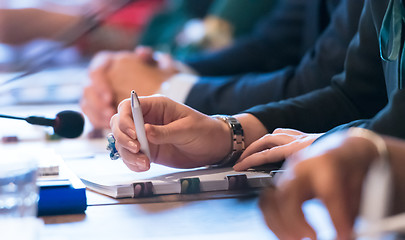 Image showing close up of business people taking notes