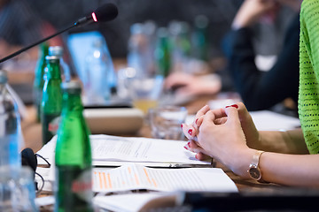 Image showing close up of business people taking notes