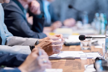 Image showing close up of business people taking notes