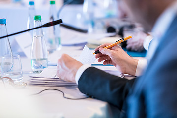 Image showing close up of business people taking notes