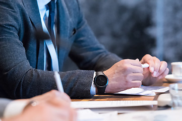 Image showing close up of business people taking notes