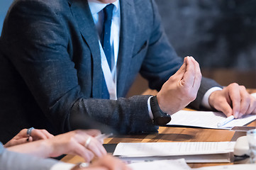 Image showing close up of business people taking notes