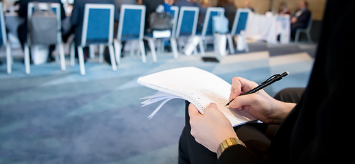 Image showing close up of business people taking notes