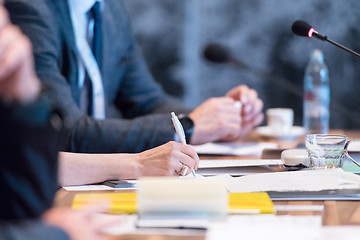 Image showing close up of business people taking notes