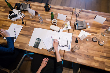 Image showing top view of business people hands taking notes