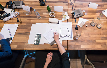 Image showing top view of business people hands taking notes