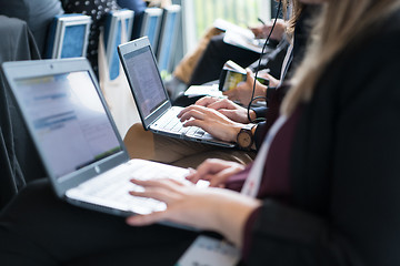 Image showing close up of business people hands using laptop computer