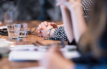 Image showing close up of business people taking notes