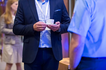 Image showing closeup of businessman holding a cup of coffee