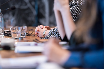 Image showing close up of business people taking notes