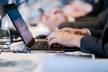 Image showing close up of business people hands using laptop computer