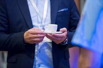 Image showing closeup of businessman holding a cup of coffee