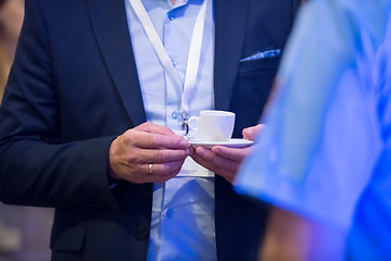 Image showing closeup of businessman holding a cup of coffee