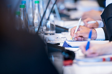 Image showing close up of business people taking notes