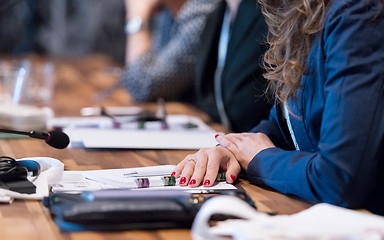 Image showing close up of business people taking notes