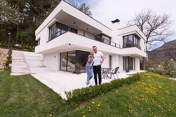 Image showing couple hugging in front of  new luxury home