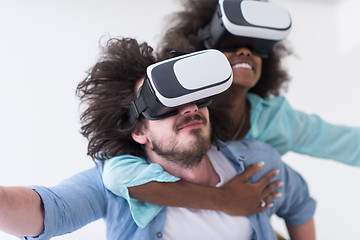 Image showing multiethnic couple getting experience using VR headset glasses