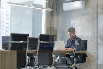 Image showing businessman working using a laptop in startup office