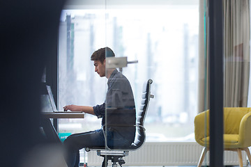 Image showing businessman working using a laptop in startup office