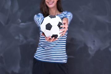 Image showing woman holding a soccer ball in front of chalk drawing board