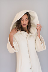 Image showing woman in a white coat with hood isolated on white background