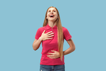 Image showing The happy business woman standing and smiling against blue background.