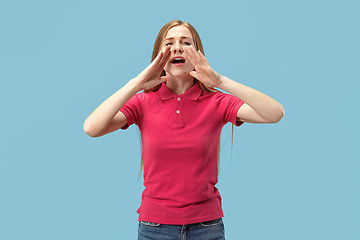 Image showing Isolated on pink young casual woman shouting at studio